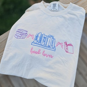 Book Lover Embroidered Shirt – Colorful Book Stack Tee – Comfort Colors Unisex Tee – Reader Gift, Teacher Gift, Literary Shirt