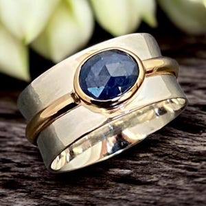 Anello con zaffiro blu in oro 9 carati e argento sterling, un gioiello moderno e di grande impatto.