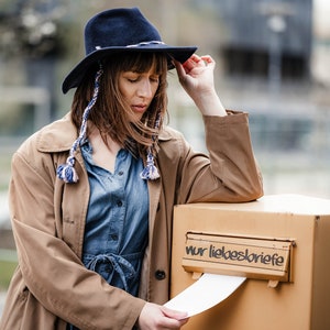 blue colored fedora with wool tassels