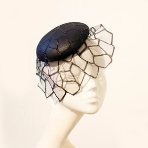 Elegant black leather fascinator with a dramatique black veil