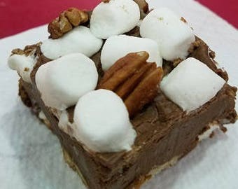 May include: A square of chocolate fudge topped with mini marshmallows and chopped pecans.