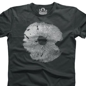 May include: A dark grey t-shirt featuring a white mushroom graphic print. The mushroom is stylised with a circular shape and radiating lines.