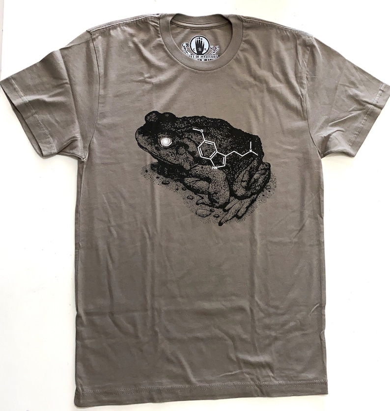 May include: A gray t-shirt with a black and white illustration of a toad with a chemical structure on its back. The text "Art of Molecules" is on the tag.