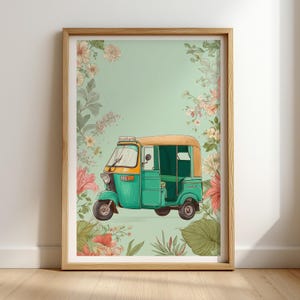 May include: Framed art print featuring a teal and yellow auto rickshaw, surrounded by floral illustrations in pink, peach, and green. The artwork has a light green background and is encased in a wooden frame.