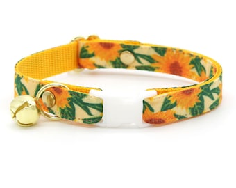 May include: A yellow cat collar with a sunflower print and a gold bell. The collar has a white plastic buckle.