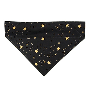 May include: Black fabric dog bandana with a gold star pattern.