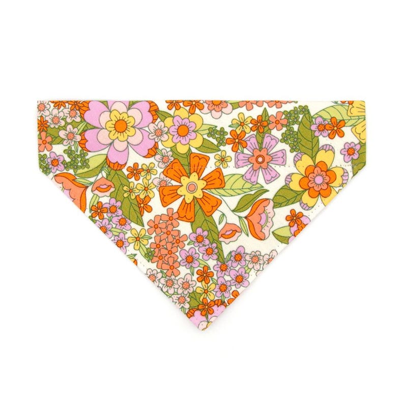 May include: A white bandana with a retro floral print featuring orange, pink and yellow flowers. The bandana has a triangular shape and is perfect for adding a touch of vintage style to any outfit.