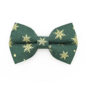 May include: A green bow tie with a gold snowflake pattern.