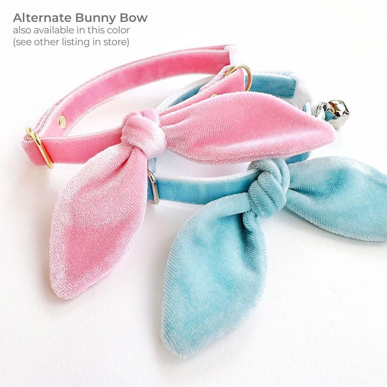 May include: Two velvet cat collars with bunny bow ties. One collar is pink and the other is light blue.