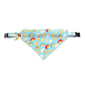 May include: A light blue dog bandana with a pattern of various types of cheese. The bandana has a black adjustable buckle and a gold bell.