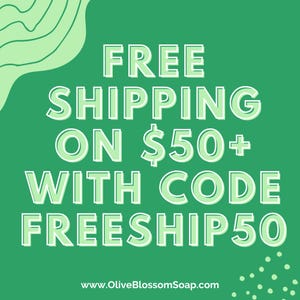 May include: A green background with white text that reads "FREE SHIPPING ON $50+ WITH CODE FREESHIP50". The website address www.OliveBlossomSoap.com is at the bottom. There are green abstract shapes in the upper left corner and white dots in the lower right corner.