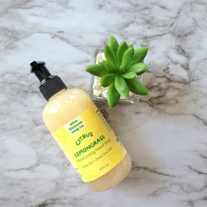 May include: A clear plastic bottle of yellow Citrus Lemongrass moisturizing hand soap with a black pump dispenser. The label reads Olive Blossom Soap Co., Citrus Lemongrass, Moisturizing Hand Soap, Olive Oil + Dead Sea Salt, 8 Fl Oz.