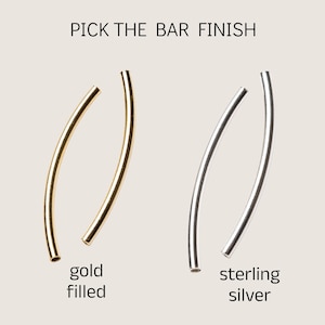 May include: Two curved metal bars, one gold filled and one sterling silver, for jewelry making.