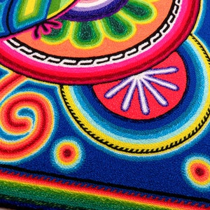 May include: A colourful embroidered artwork featuring a spiral design, a flower, and a bird. The artwork is made with vibrant colours, including red, orange, yellow, green, blue, and purple.