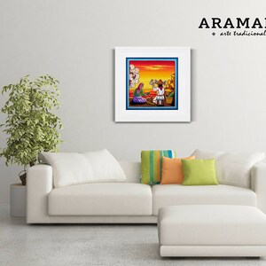 May include: A framed artwork depicting a colorful scene with two figures in traditional clothing. The artwork is titled "ARAMARA arte tradicional" and is displayed on a white wall above a white couch with pillows.