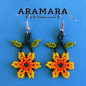 May include: A pair of beaded earrings featuring a flower design with yellow, orange, and green beads. The earrings are made with traditional techniques and have silver hooks.