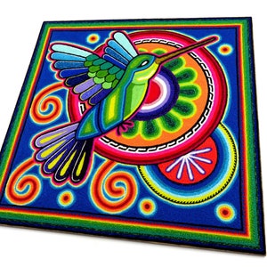 May include: A colourful, hand-painted hummingbird with a long beak, surrounded by swirling patterns and circles in shades of blue, green, orange, red, and yellow. The artwork is created using a technique called "string art" where coloured threads are woven into a design.
