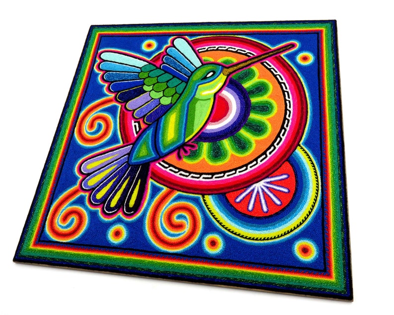 May include: A colourful, hand-painted hummingbird with a long beak, surrounded by swirling patterns and circles in shades of blue, green, orange, red, and yellow. The artwork is created using a technique called "string art" where coloured threads are woven into a design.