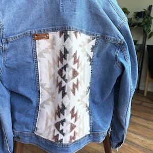 May include: A handmade wooden sign with the text "Welcome" in a playful font. The sign features a distressed white background and a dark brown frame, perfect for a front door or entryway. The sign measures approximately 12 inches wide and 6 inches tall.