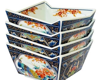 May include: A stack of four square ceramic bowls with an angled rim. The exterior features a dark blue background with gold scrollwork, orange floral patterns, and a colorful peacock illustration. The interior rim is decorated with orange floral motifs.