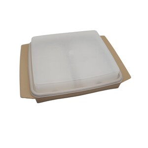 May include: A beige square food storage container with a clear, frosted lid. The container has a slightly raised rim and a flat base. The lid fits snugly over the container, creating an airtight seal. The container is designed for storing food.