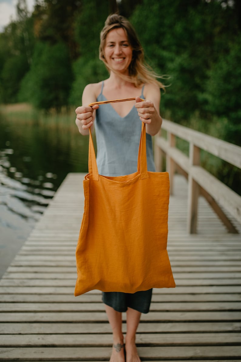 May include: A yellow tote bag with long straps.