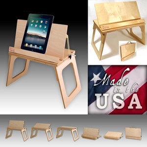 May include: A wooden laptop stand with a tablet in the stand. The stand is foldable and has a built-in pencil holder. The stand is made in the USA. The stand is shown in different positions.