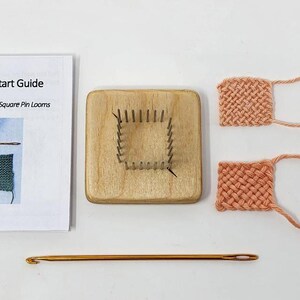 May include: A set of two square pin looms with instructions and a crochet hook. The looms are made of wood and have metal pins. The crochet hook is gold. The looms are used to create small squares of fabric.