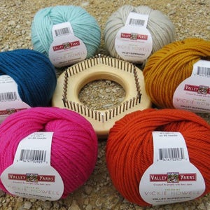 May include: Six balls of yarn in various colors, including teal, light blue, gray, orange, pink, and yellow. Each ball has a white label with the text "Valley Yarns" and "Vickie Howell" printed on it.