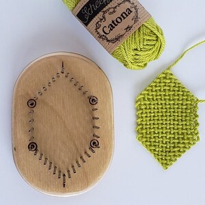 May include: A wooden loom with a circular row of pegs, a ball of lime green yarn labeled "Scheepjes Catona", and a lime green woven piece.