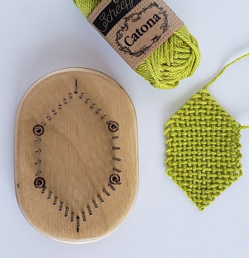 May include: A wooden loom with a circular row of pegs, a ball of lime green yarn labeled "Scheepjes Catona", and a lime green woven piece.