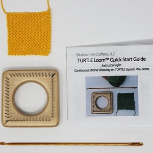 May include: A craft kit featuring a wooden square loom with a central hole, a yellow knitted square, a crochet hook, and a guide titled "TURTLE Loom Quick Start Guide" by Bluebonnet Crafters, LLC. The guide provides instructions for continuous strand weaving.