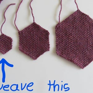 May include: Three woven hexagonal shapes in various sizes, made with a deep burgundy yarn. The smallest hexagon is at the bottom of the image with an arrow pointing up and the words "weave this" written below it.