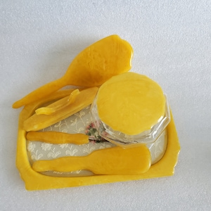 May include: A yellow plastic vanity set with a tray, a comb, a brush, and a small jar with a lid. The tray has a floral design.