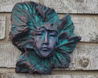 Art for your garden wall, fence and gate, handcrafted sculpture of a female face surrounded by leaves.  Winter by Gable Gargoyles