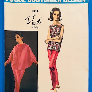 May include: Vogue Couturier Design pattern 1394 by Pucci of Italy. The pattern features two women wearing pink and red outfits. The woman on the left is wearing a pink top and pants, while the woman on the right is wearing a red top and pants with a floral print.