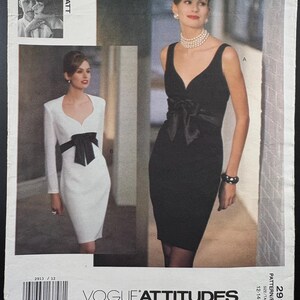 May include: Vogue Attitudes sewing pattern featuring two elegant dresses. One is a long-sleeved white dress with a black bow, and the other is a black sleeveless dress with a bow. The pattern number is 2913.