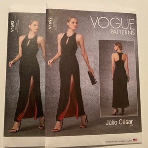 May include: Vogue Patterns sewing pattern for a black maxi dress with a front slit and a keyhole neckline. The pattern is designed by Júlio César and is for sizes 8-16.