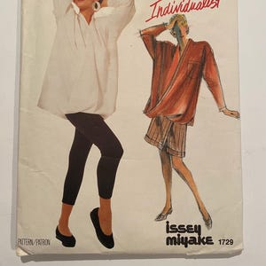 May include: Vogue Patterns Individualist sewing pattern featuring Issey Miyake designs. The cover shows illustrations of two figures wearing oversized tops and leggings. The pattern number is 1729.