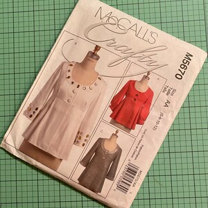 May include: A vintage McCall's Crafty sewing pattern for a women's jacket. The pattern is for sizes 6-8-10-12 and features a white jacket with gold buttons, a red jacket with black buttons, and a gray jacket with silver buttons. The pattern number is M5670.