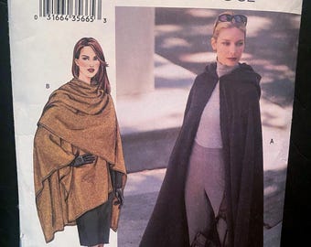 Puede incluir: Un sobre de patrón de costura Very Easy Vogue 7641 con ilustraciones de dos prendas: un poncho envolvente color canela marcado como B y una capa larga negra con capucha marcada como A. El sobre incluye un código de barras y el texto 7641 PATTERN/PATRON.