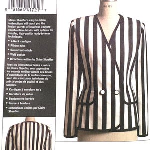 May include: A sewing pattern envelope for V8400 Claire Shaeffer's Custom Couture Collection, featuring a double-breasted V-neck cardigan with black and white vertical stripes, ribbon trim, welt pockets, and bound buttonholes, shown on a mannequin.