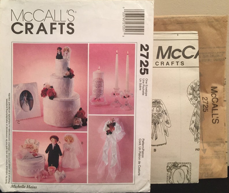 May include: A wedding themed craft pattern set with instructions for making a cake, a picture frame, a candle, a bouquet, and a box. The pattern is from McCall's Crafts and the pattern number is 2725.