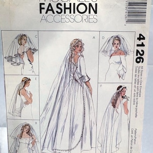 May include: A McCall's Fashion Accessories sewing pattern envelope, number 4126, featuring illustrations of various bridal veils and headpieces. The white paper envelope displays six distinct sketches labelled A through F, showcasing different veil lengths and styles.