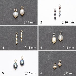 May include: Six pairs of pearl and gemstone jewellery pendants with gold and silver findings. The pendants are arranged in two rows of three. The pendants are all different sizes and shapes. The pendants are all white, black, and grey.