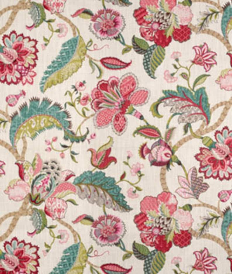 May include: A floral fabric with a white background and a repeating pattern of pink, red, and green flowers. The flowers are stylised and have intricate details.