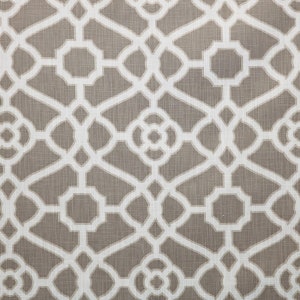 May include: A brown fabric with a white geometric pattern. The pattern is a repeating design of interlocking circles and squares.