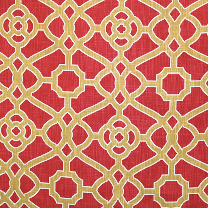 May include: Red fabric with a gold geometric pattern. The pattern is a repeating design of squares and circles.