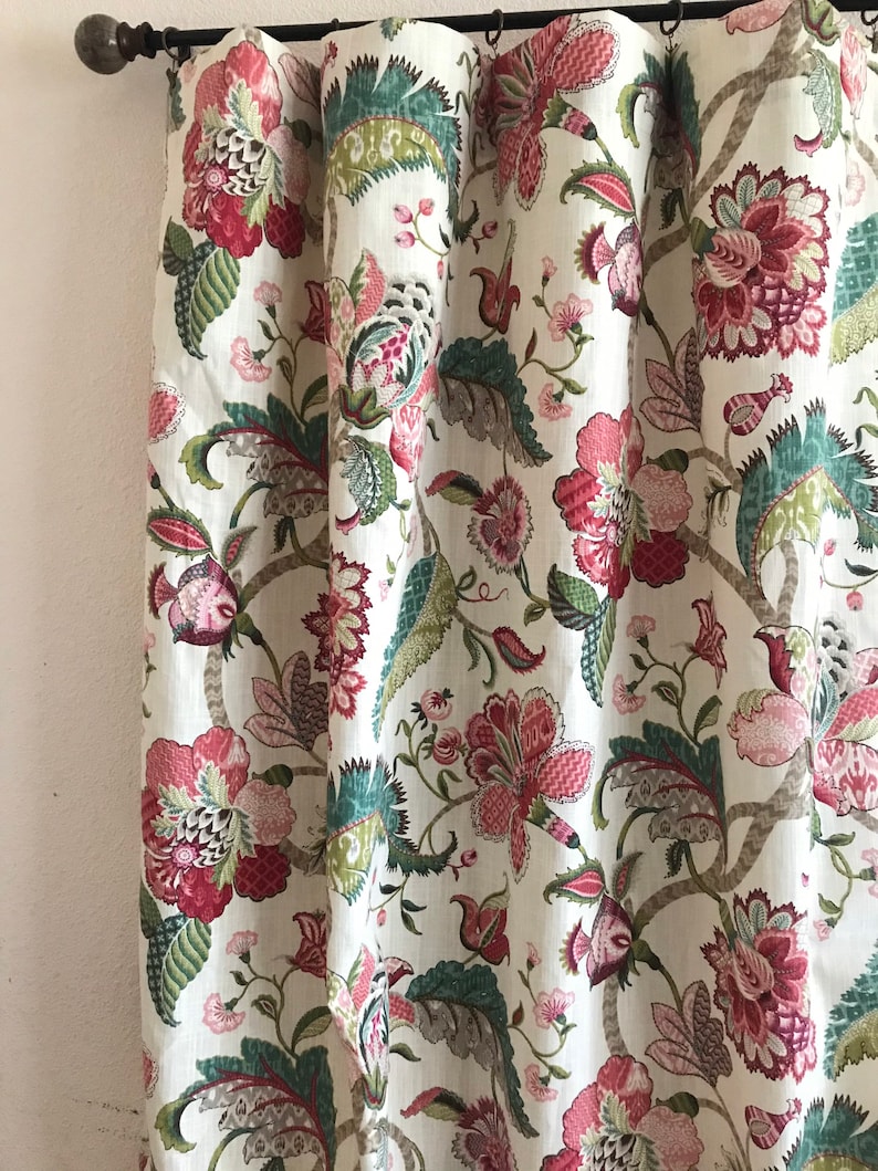 May include: White fabric curtain with a floral pattern in shades of pink, green, and brown. The pattern features large flowers and leaves.