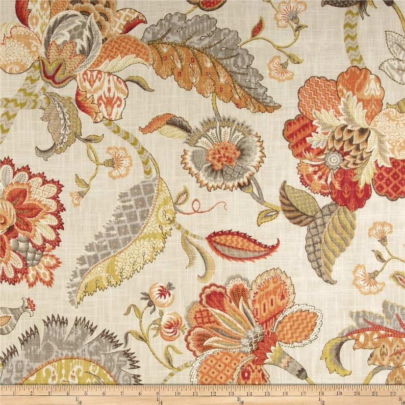 May include: A beige fabric with a floral pattern in shades of orange, red, and grey. The flowers are intricate and detailed, with a variety of shapes and sizes. The fabric is perfect for upholstery, curtains, or other home decor projects.